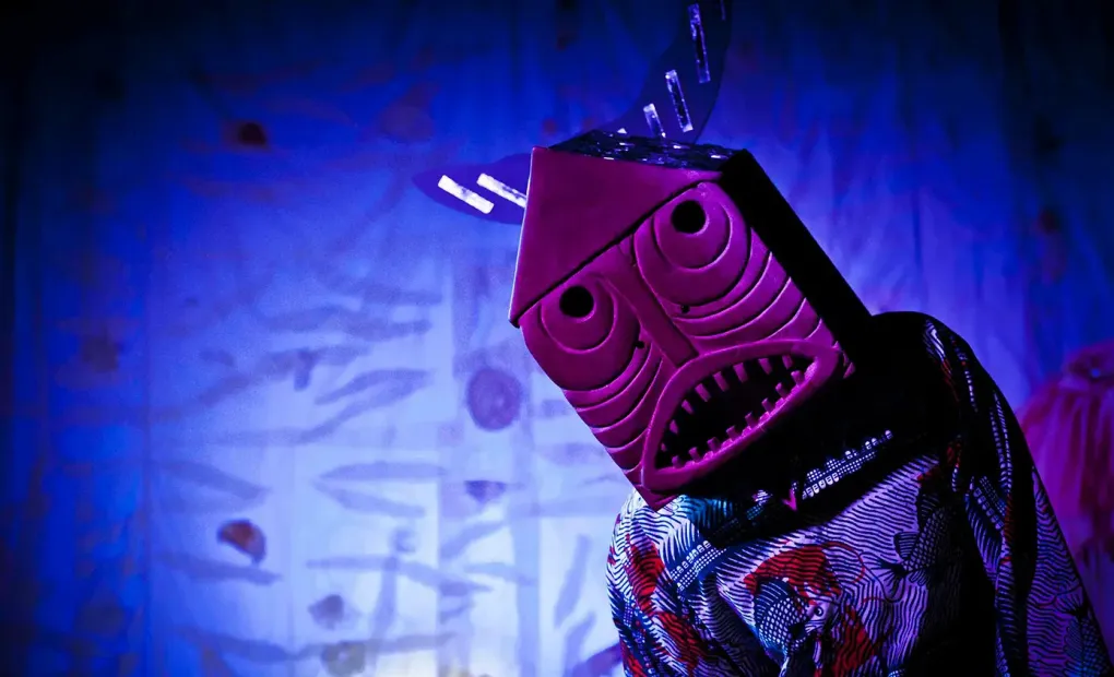 En skådespelare med mask över huvudet från föreställningen Flickan och havssköldpaddan.