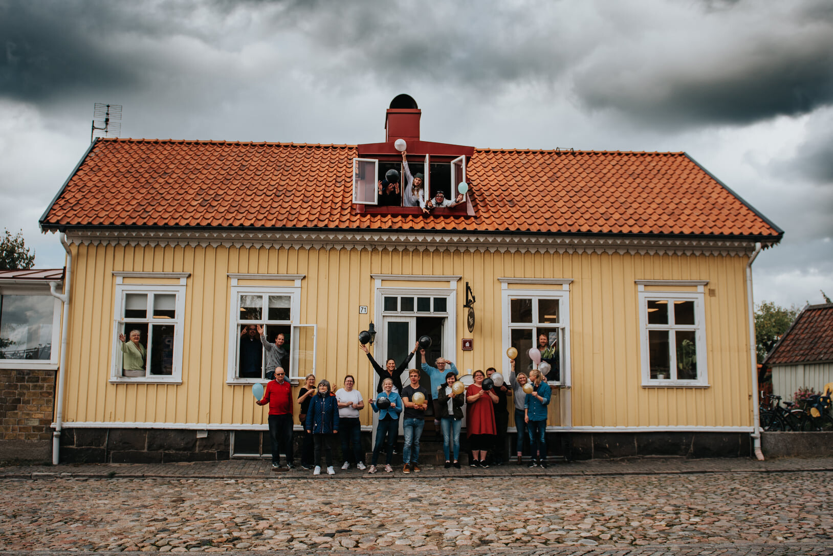 Bild på fontänhuset i Falkenberg med glada människor som firar att det funnits i 20 år.